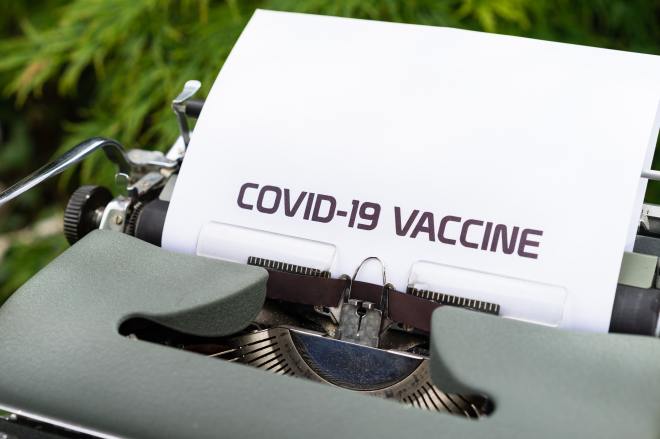 Typewriter with COVID-19 vaccine text on a piece of paper