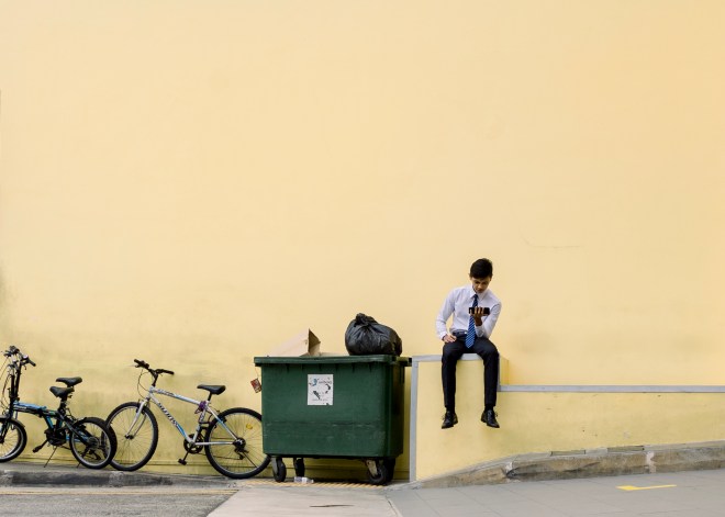 Young man in business wear against a beige background
