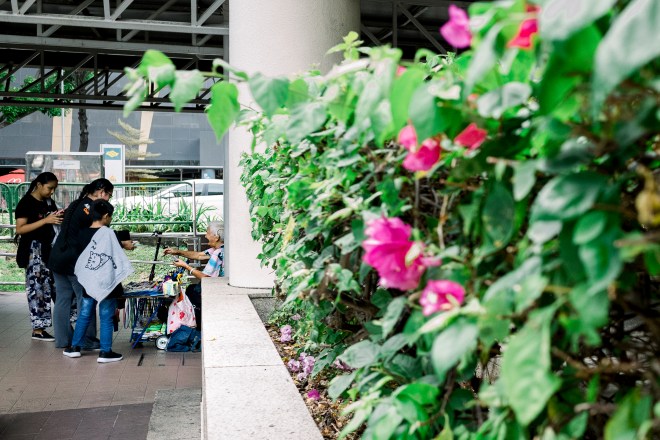 Elderly woman selling tissue papers in the background