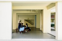 Hairdresser giving a haircut at a HDB void deck