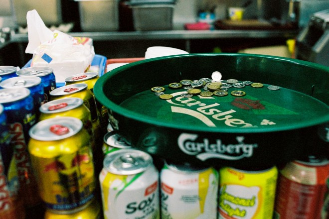 Green serving tray on a selection of canned beverages
