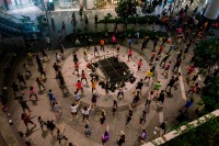 Group of dancers in circles around a stage (Photo by Ng Shi Wen)