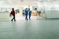 Nurses in blue walking out of a food court (Photo by Ng Shi Wen)