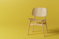 Wooden chair against yellow background (Photo by YU Carla on Unsplash)