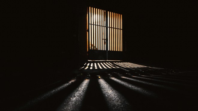Dark prison-like gate (Photo by Ayrus Hill on Unsplash)